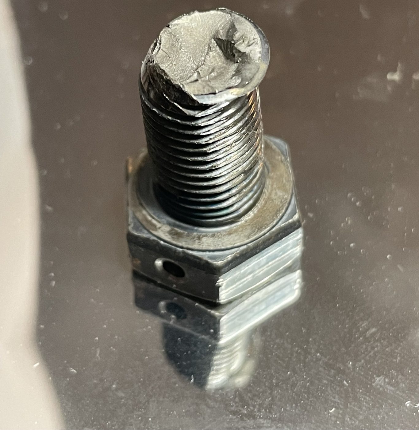 The hexa bolt shows sign of fatigue fracture due to torsional shear or overload, with fatigue origin.